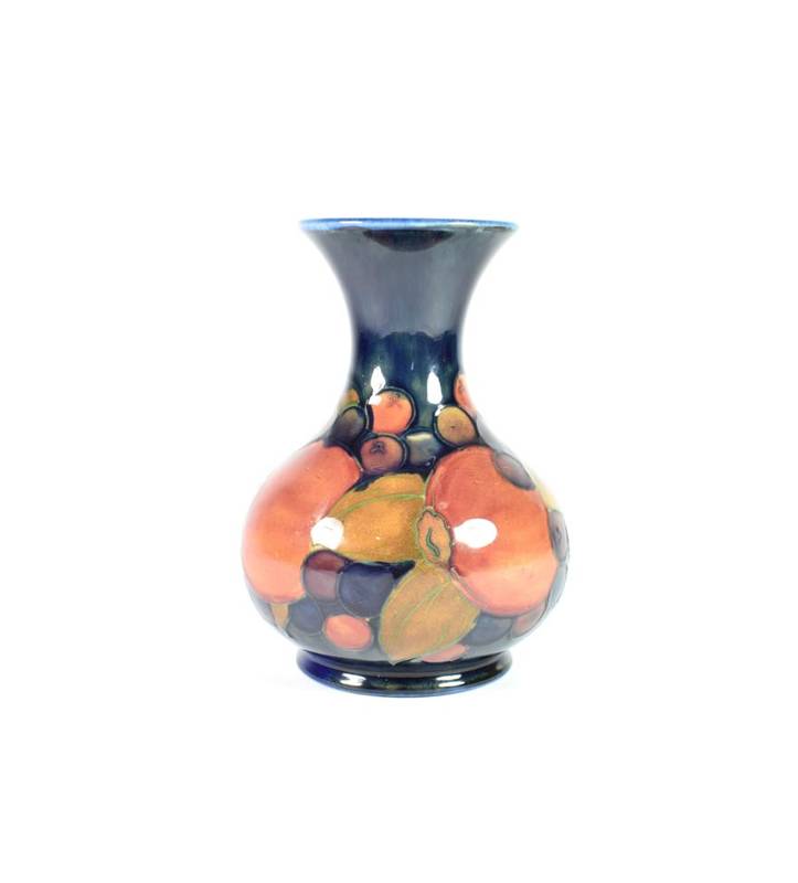 Lot 223 - William Moorcroft (1872-1945): A Pomegranate Pattern Vase, on a blue ground, impressed factory...