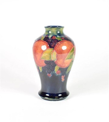 Lot 224 - William Moorcroft (1872-1945): A Pomegranate Pattern Baluster Vase, on a blue ground, impressed...