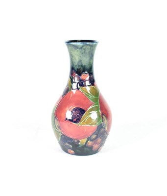 Lot 225 - William Moorcroft (1872-1945): A Pomegranate Pattern Vase, on a blue ground, impressed factory...