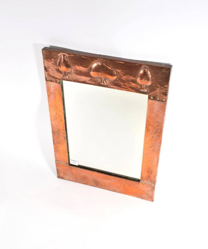 Lot 248 - A Liberty & Co. Ltd Copper Rectangular Wall Mirror, the top with stylised decoration, riveted...