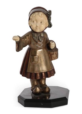 Lot 254 - An Art Deco Bronze and Ivory Figure, modelled as a Dutch girl, holding a basket in one arm and...