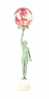 Lot 256 - An Art Deco Green Patinated Spelter Figural Lamp, modelled as a nude holding a globe, on a circular