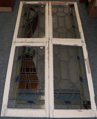 Lot 259 - A Set of Four Stained Glass Window Panels, forming a scene of a galleon at sea within blue and...