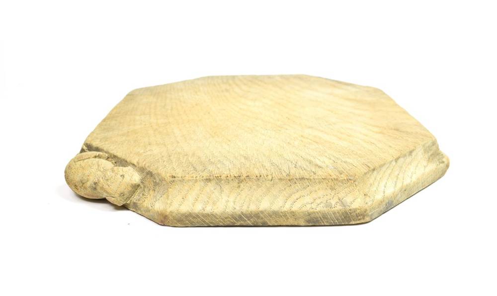 Lot 276 - Mouseman: A 1930's/40's Robert Thompson of Kilburn English Oak Bread Board, with carved mouse...