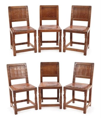 Lot 280 - Mouseman: A Set of Six Robert Thompson of Kilburn English Oak Panel Back Dining Chairs, nailed hide