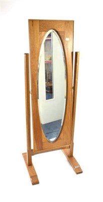 Lot 363 - Yorkshire School: An English Oak Cheval Mirror, the octagonal posts supporting a bevelled glass...
