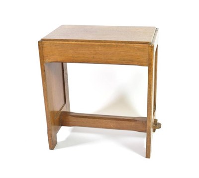 Lot 367 - An Arts & Crafts Cumbria School Oak Stool, solid top with panelled sides joined by a pegged...