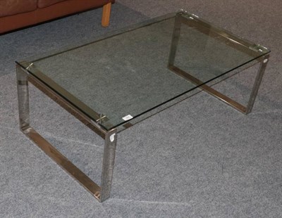Lot 384 - A Glass Top and Chromed Metal Coffee Table, modern, of rectangular form, on square form tubular...