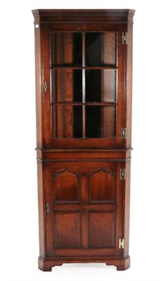 Lot 421 - A Kumpers of Salisbury Oak Free-Standing Corner Cabinet, modern, the upper section with a door...