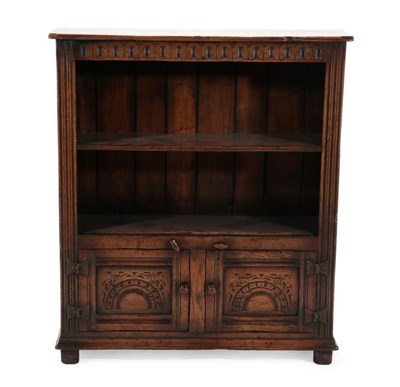 Lot 422 - A Titchmarsh & Goodwin Style Oak Bookcase, model RL.41, modern, the nulled frieze above two...