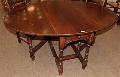 Lot 423 - A Titchmarsh & Goodwin Style Oak Six-Seater Gateleg Table, modern, with rounded dropleaves...