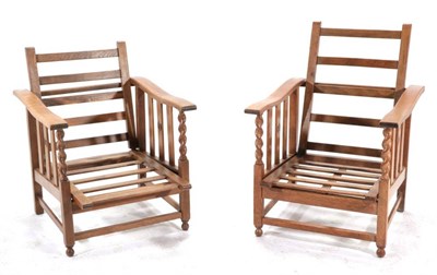 Lot 427 - A Pair of Early 20th Century Oak Reclining Armchairs, the hinged and pivoting ladder back...