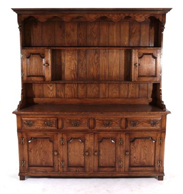 Lot 428 - An Oak Dresser and Rack, modern, the upper section with two shelves and two moulded cupboard doors
