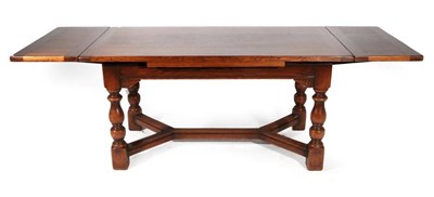 Lot 431 - A Solid Oak Drawleaf Extending Dining Table, modern, of rectangular form, on baluster turned...