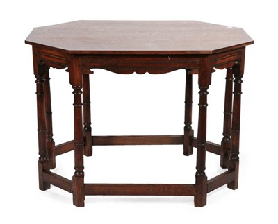 Lot 433 - An Oak Centre Table, 20th century, of octagonal shaped form with moulded frieze, on gun barrel...