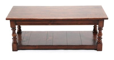 Lot 437 - An Oak Rectangular Coffee Table, modern, on baluster turned legs joined by a shelf with block feet