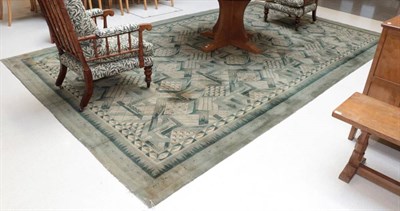 Lot 449 - An Art Deco Carpet, circa 1930, machine made in four strips, the mint green and cream field of...