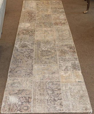 Lot 451 - A Narrow ''Modernist'' Patchwork Runner, comprised of panels from various rugs, 298cm by 83cm;...