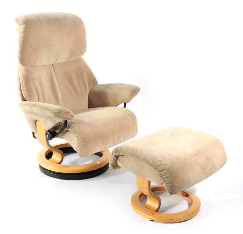 Lot 483 - An Ekornes Revolving and Reclining Armchair, modern, upholstered in beige velvet, with beech frame