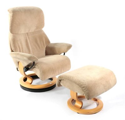 Lot 483 - An Ekornes Revolving and Reclining Armchair, modern, upholstered in beige velvet, with beech frame