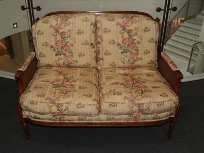 Lot 484 - A Pair of Walnut Show-Frame Milano Two-Seater Sofas, retailed by Geoffrey Benson & Son, upholstered