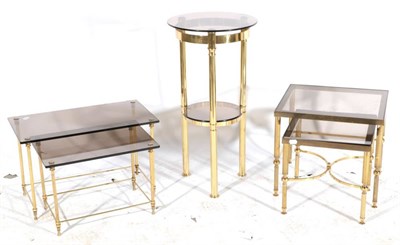 Lot 514 - A Nest of Two Glass Top and Brass Tables, the glass tinted tops on reeded tubular legs joined...
