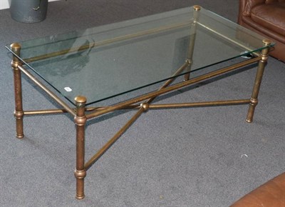 Lot 516 - A 1970's Glass Rectangular Coffee Table, with brass tubular frame, the legs joined by a cross-frame
