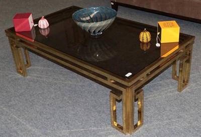 Lot 522 - A 1970's Brass and Glass Top Coffee Table, of rectangular form with square tubular frame, 130cm...