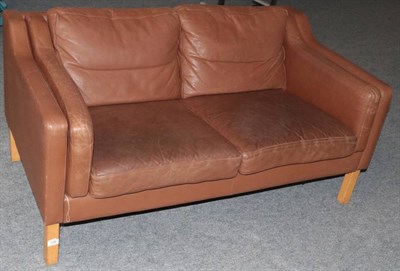 Lot 536 - A 1970's Danish Two-Seater Sofa, in the manner of Borge Mogensen, covered in brown leather,...