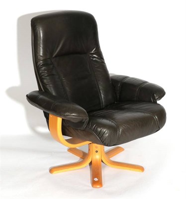 Lot 539 - A Danish Stouby Black Leather Swivel Armchair, the padded arms with curved arm supports, on...