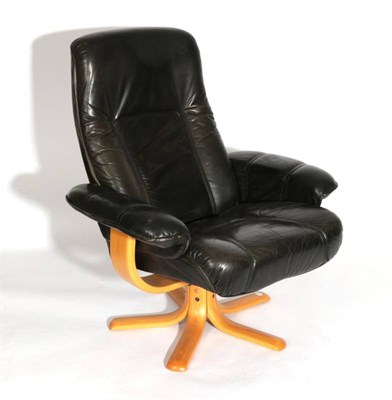 Lot 542 - A Danish Stouby Black Leather Swivel Armchair, the padded arms with curved arm supports, on...