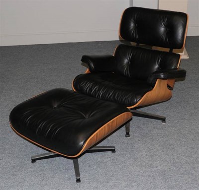 Lot 550 - After Charles and Ray Eames: A Cherry 670 Lounge Chair and 671 Ottoman, modern, with black...