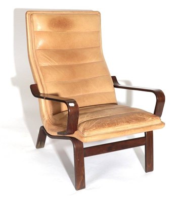 Lot 561 - A 1970's Danish Formed Laminate Armchair, covered in tan leather, with rounded arm supports,...