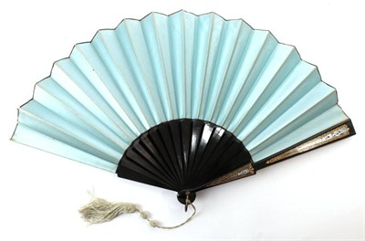 Lot 2081 - A Late Victorian Fabric Fan, mounted on black wooden sticks, with unusual gold and ice blue...