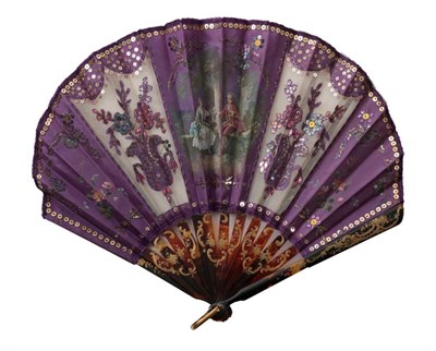Lot 2099 - A Circa 1900 Fan of Ballon Form, the bold violet gauze and silk overlaid leaf embellished with...