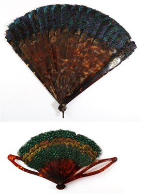 Lot 2137 - A 19th Century Tortoiseshell Brisé Fan, topped with iridescent blue feathers, the upper guard with