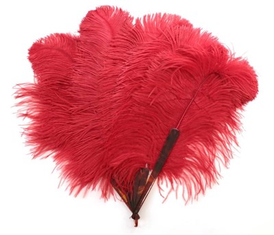Lot 2144 - An Early 20th Century Strong Strawberry Red Ostrich Feather Fan, with four tortoiseshell gorge...