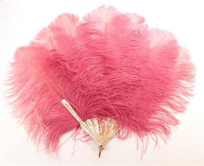 Lot 2145 - An Early 20th Century Raspberry Pink/Slightly Shaded Ostrich Feather Fan, the feathers mounted...