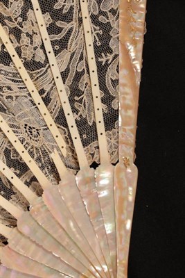 Lot 2164 - A Late 19th/Early 20th Century Brussels Point De Gaze Needlelace Fan, the leaf mounted on pink...