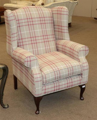 Lot 574 - Laura Ashley Wingback Chair, modern, covered in tartan printed fabric, raised on mahogany...