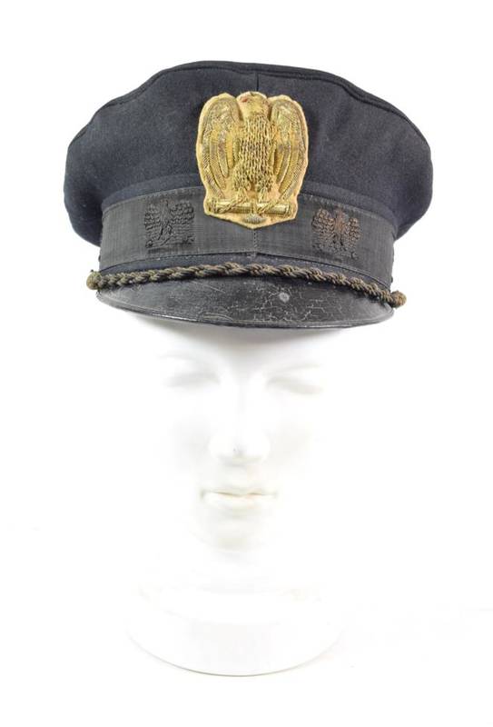 Lot 76 - A Second World War Italian Fascist Officer's Black Wool Peaked Cap, the black gros grain centreband