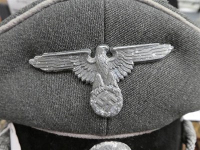 Lot 94 - A German Third Reich Waffen-SS Infantry Officer's Peaked Cap, in field grey wool, with white...