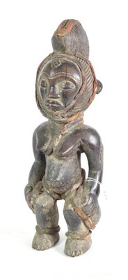 Lot 179 - An Early 20th Century Punu Carved Wood Figure, West Africa, as a woman with red cloth bound...