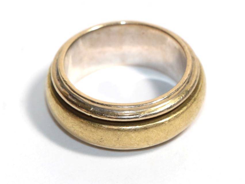 Lot 21 - A yellow and white metal band ring, stamped '750', finger size L