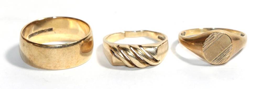 Lot 24 - A 9 carat gold band ring, finger size R1/2; a 9 carat gold signet ring, finger size Q1/2; and...