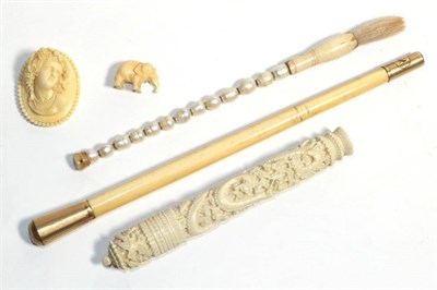 Lot 33 - A carved Chinese bodkin case with needles, carved ivory late Victorian cameo, ivory parasol handle