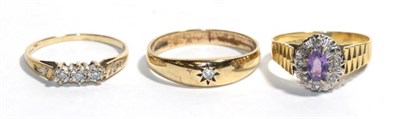 Lot 35 - A 9 carat gold diamond solitaire ring, finger size T; a 9 carat gold three stone ring, finger...