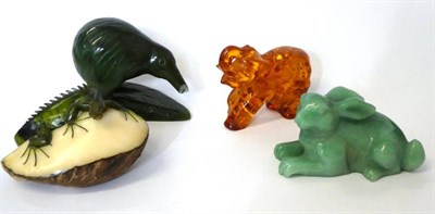 Lot 50 - An amber elephant and three other items