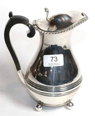 Lot 73 - A silver baluster hot water jug, William Hutton, Sheffield 1919, with gadroon rim on ball supports