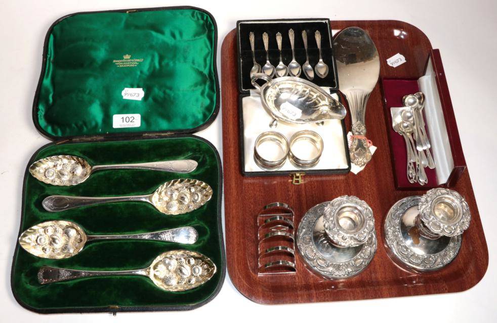 Lot 102 - A cased set of four silver plated berry spoons; pair of silver napkin rings; a silver toast rack; a
